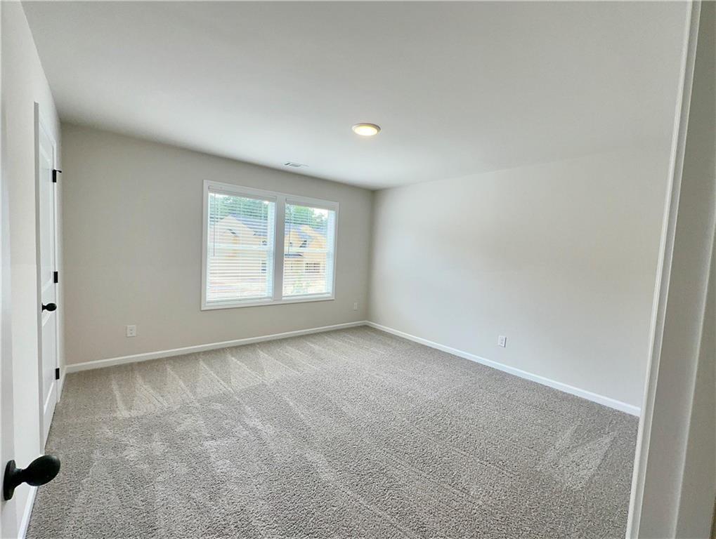 306 Rodeo Drive Auburn, GA 30011 - Photo 15 of 23 an empty room with windows