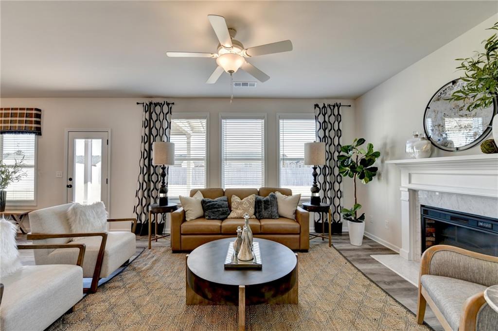 306 Rodeo Drive Auburn, GA 30011 - Photo 17 of 86 a living room with furniture a fireplace and a large window