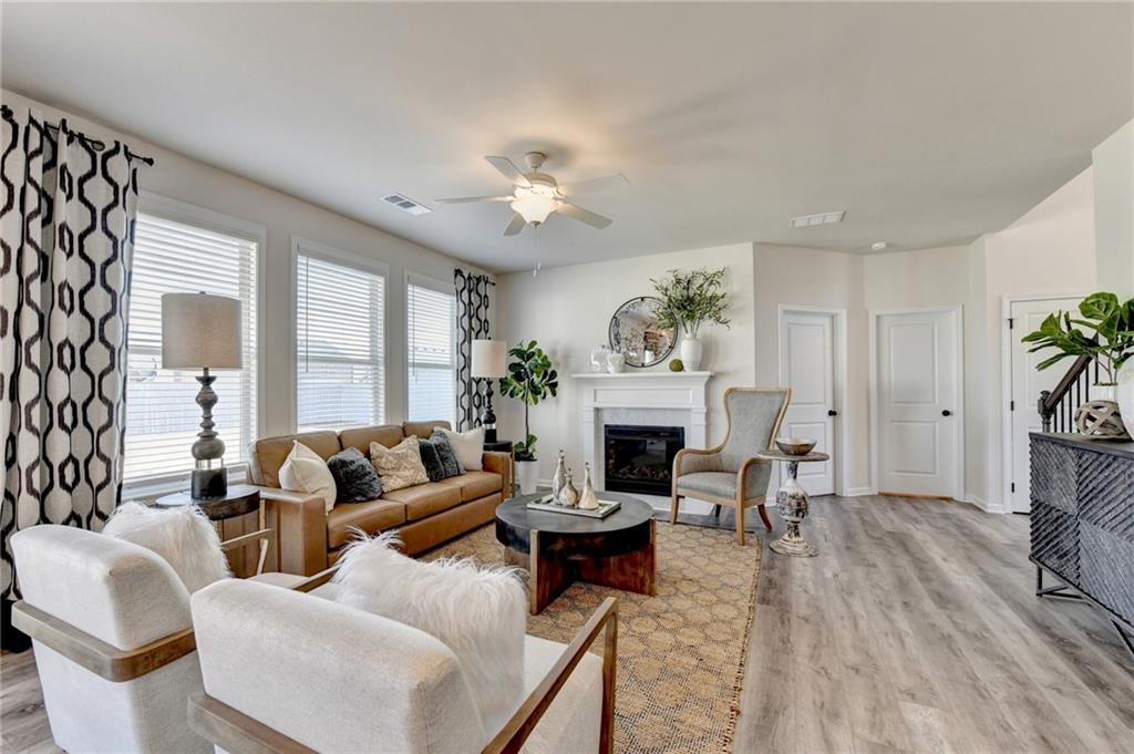 306 Rodeo Drive Auburn, GA 30011 - Photo 19 of 86 a living room with furniture a fireplace and a potted plant