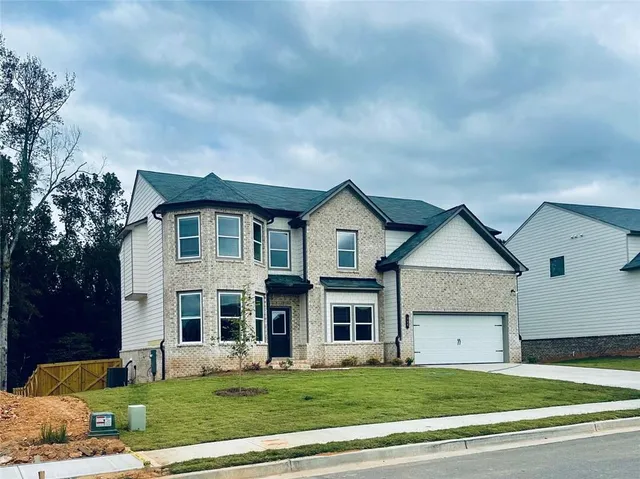 a front view of a house with a yard