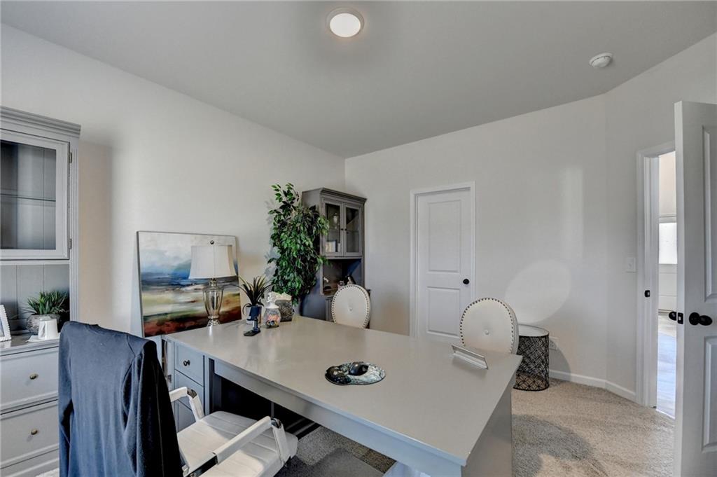 306 Rodeo Drive Auburn, GA 30011 - Photo 40 of 86 a living room with furniture and a flat screen tv