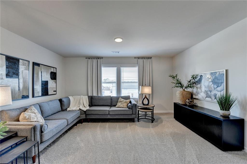 306 Rodeo Drive Auburn, GA 30011 - Photo 44 of 86 a living room with furniture and a couch