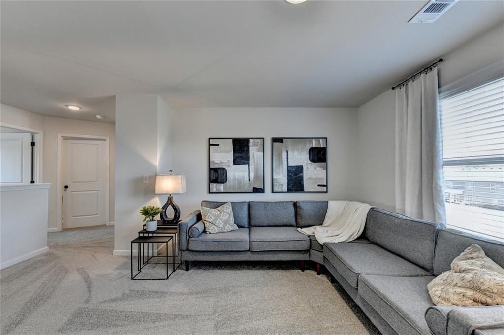 306 Rodeo Drive Auburn, GA 30011 - Photo 46 of 86 a living room with furniture and a large window