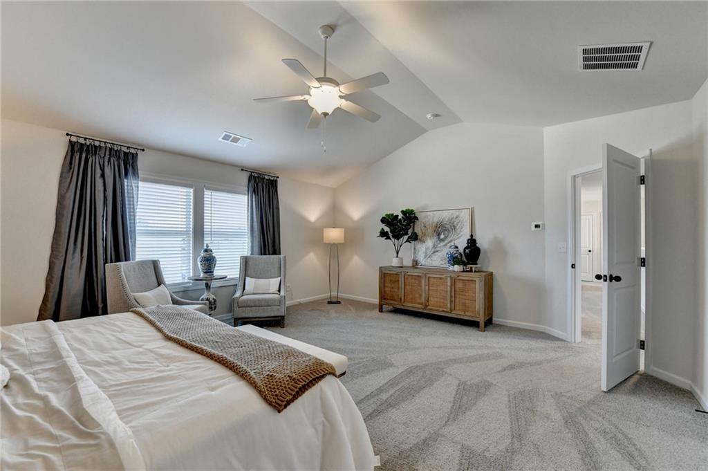 306 Rodeo Drive Auburn, GA 30011 - Photo 54 of 86 a bedroom with a bed and a couch