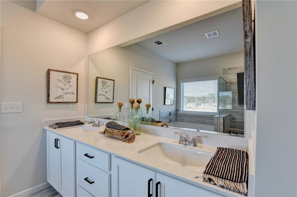 306 Rodeo Drive Auburn, GA 30011 - Photo 58 of 86 a bathroom with a sink double vanity and a mirror