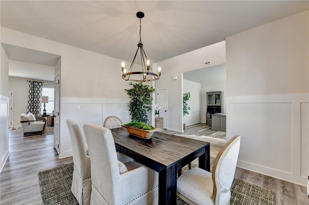 306 Rodeo Drive Auburn, GA 30011 - Photo 8 of 86 a view of a dining room with furniture and wooden floor