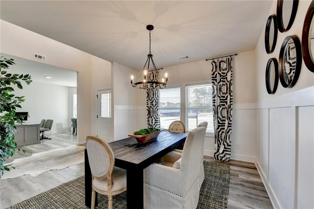 306 Rodeo Drive Auburn, GA 30011 - Photo 9 of 86 a view of a dining room with furniture window and wooden floor