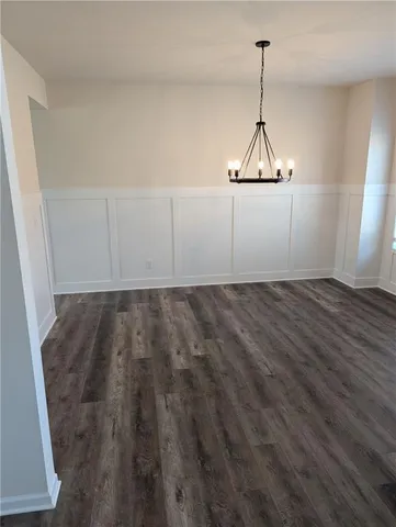 a view of a room with wooden floor and white walls