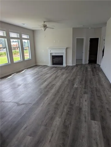 wooden floor fireplace and windows in an empty room