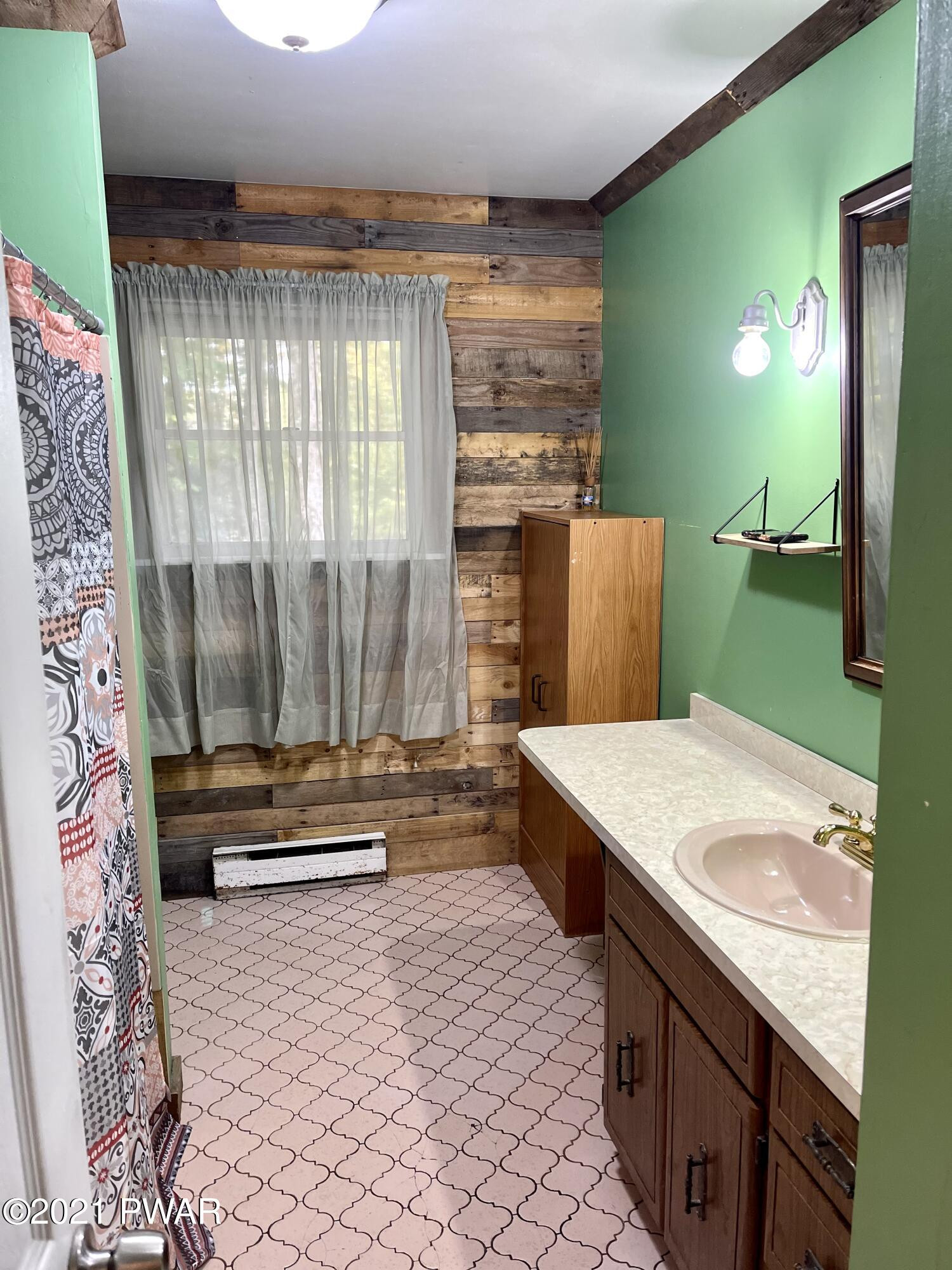 127 Estates Road Greentown, PA 18426 - Photo 47 of 85 a bathroom with a sink a mirror and a bathtub