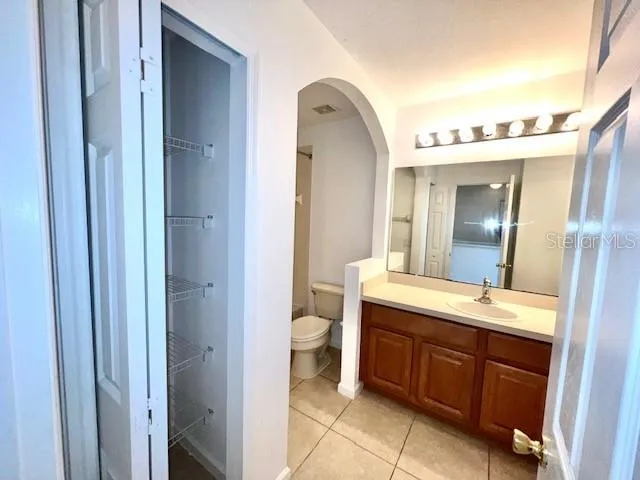 a spacious bathroom with a double vanity sink and a mirror
