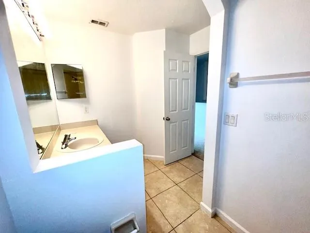 a bathroom with a sink a mirror and shower