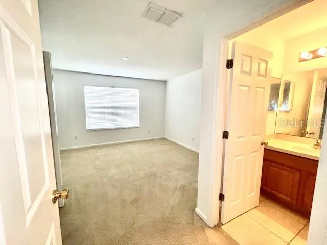a bathroom with a granite countertop sink a mirror and a shower