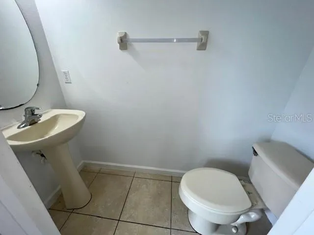 a bathroom with a sink toilet and a mirror
