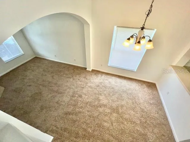 a view of a room with a sink and cabinets