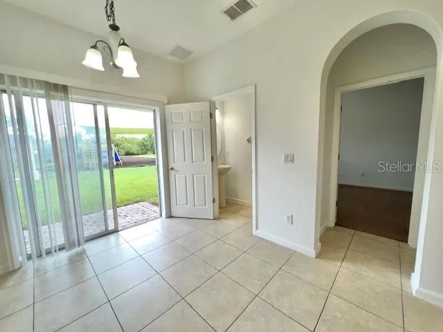 a view of a room with window and carpet