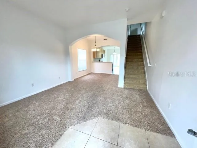 an entryway in an empty room with a fireplace