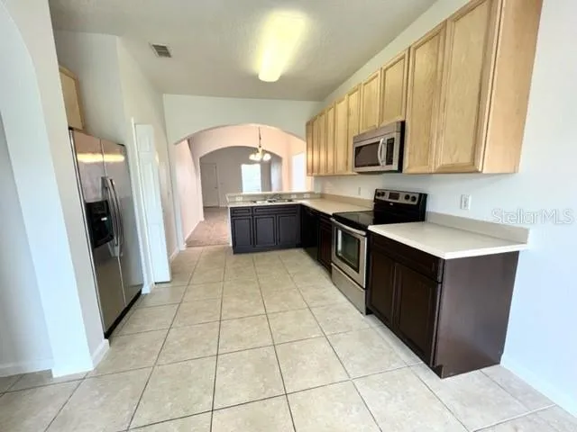 a kitchen with stainless steel appliances a sink stove and cabinets