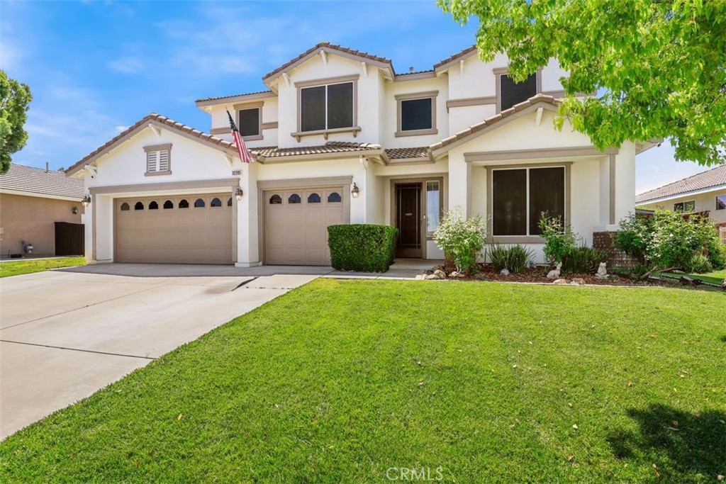 32285 Perigord Road Winchester, CA 92596 - Photo 1 of 1 a front view of a house with a yard and garage