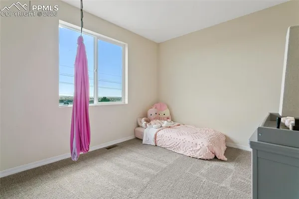 a bedroom with a bed and a couch