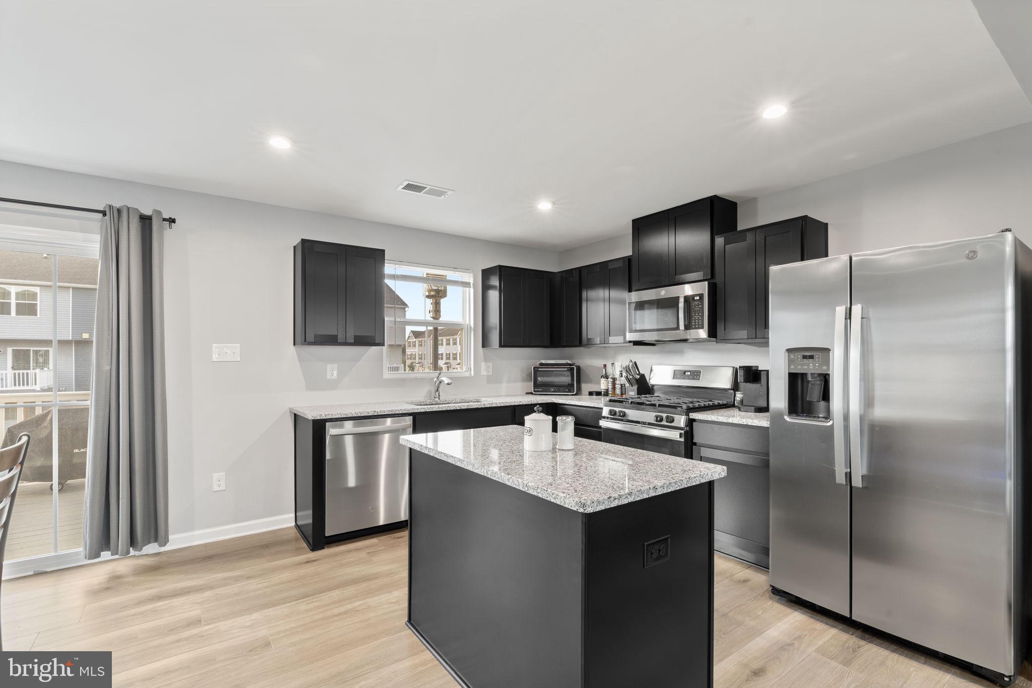 25 Wendowski Street Beverly, NJ 08010 - Photo 11 of 29 a kitchen with stainless steel appliances granite countertop a sink stove refrigerator and cabinets