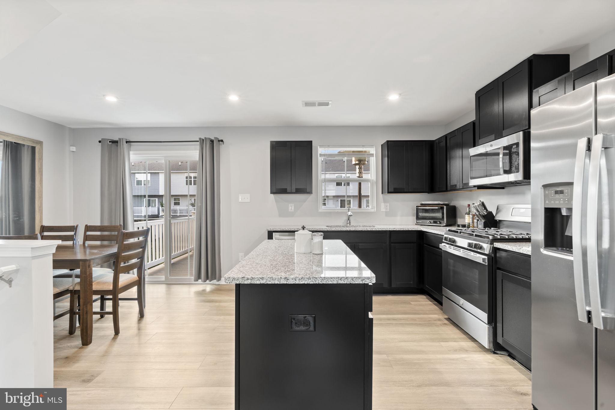 25 Wendowski Street Beverly, NJ 08010 - Photo 12 of 29 a large kitchen with stainless steel appliances kitchen island granite countertop a large stove top oven and a refrigerator