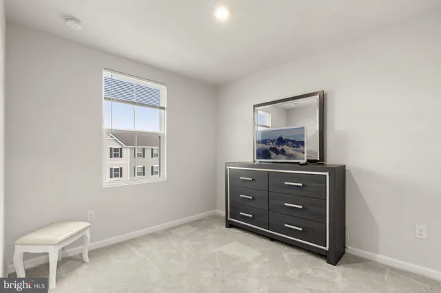 a room with a dresser and a window