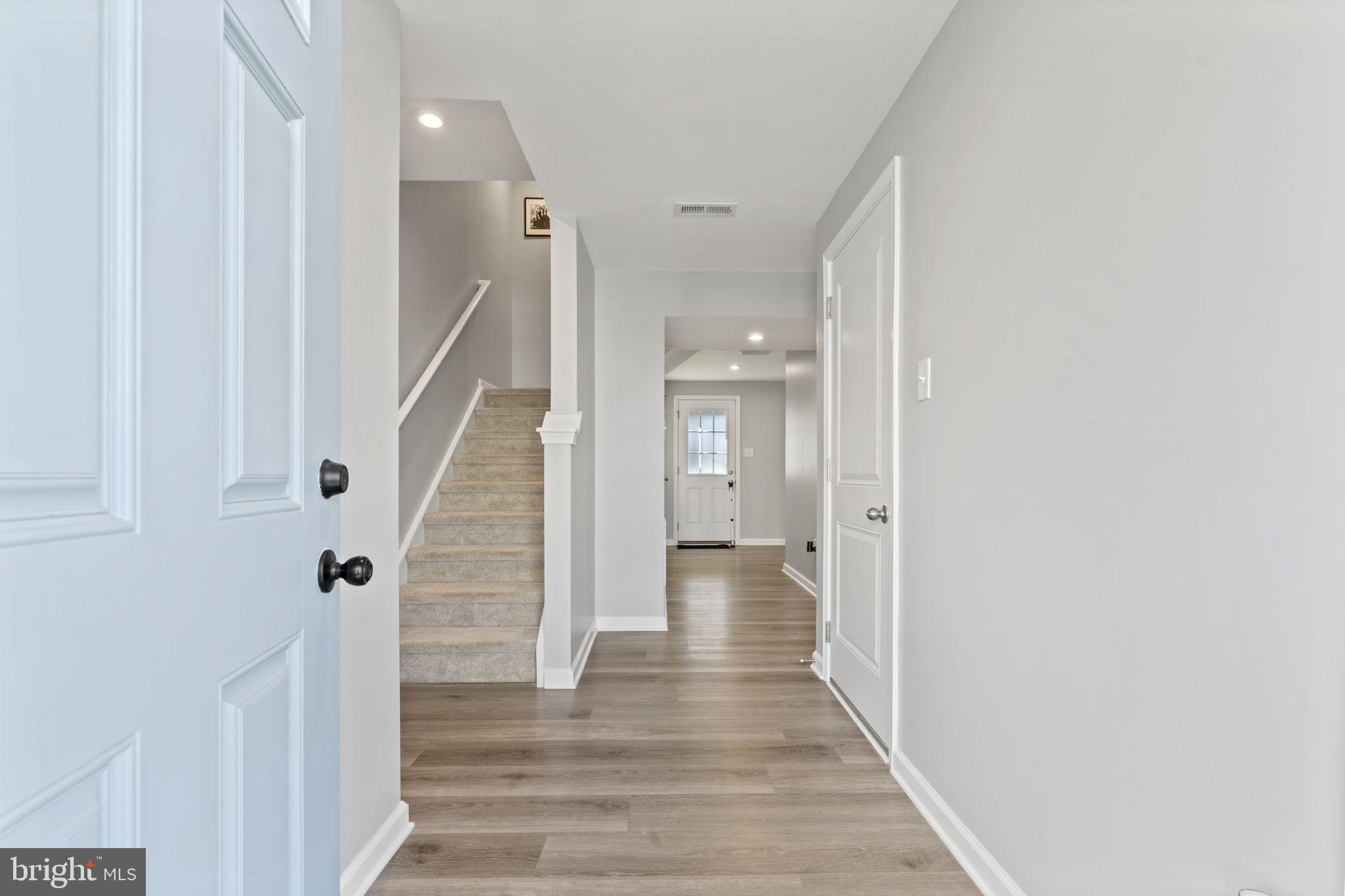 25 Wendowski Street Beverly, NJ 08010 - Photo 3 of 29 a view of a hallway with wooden floor and staircase