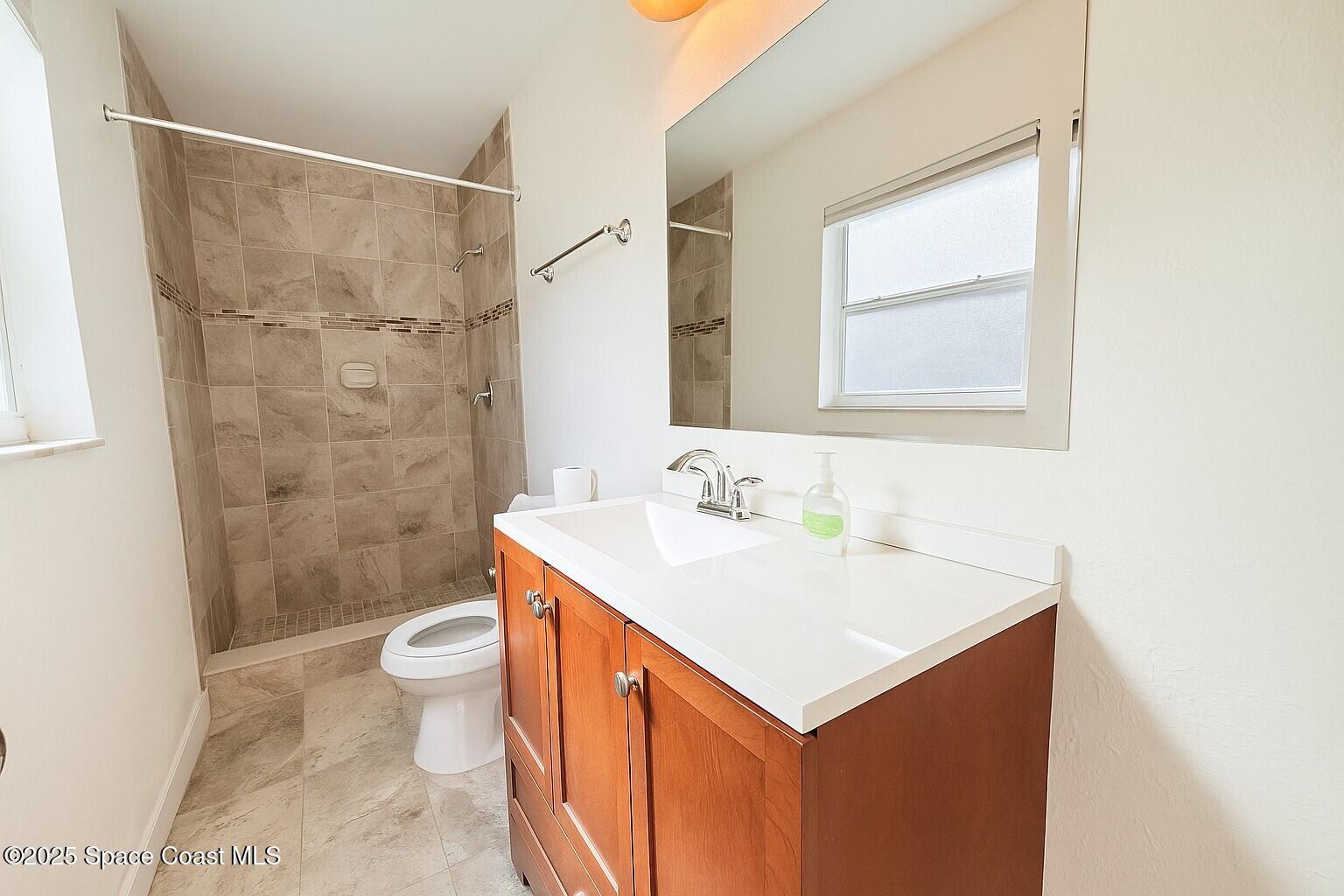 1021 Palmer Road Rockledge, FL 32955 - Photo 11 of 23 a bathroom with a sink toilet and shower