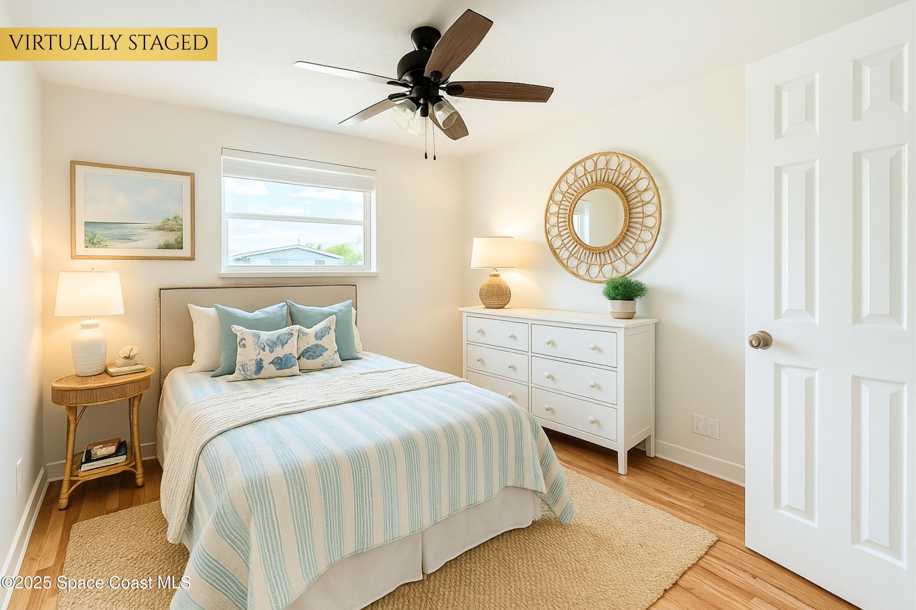 1021 Palmer Road Rockledge, FL 32955 - Photo 14 of 23 a bedroom with a bed a mirror on the dresser and a window