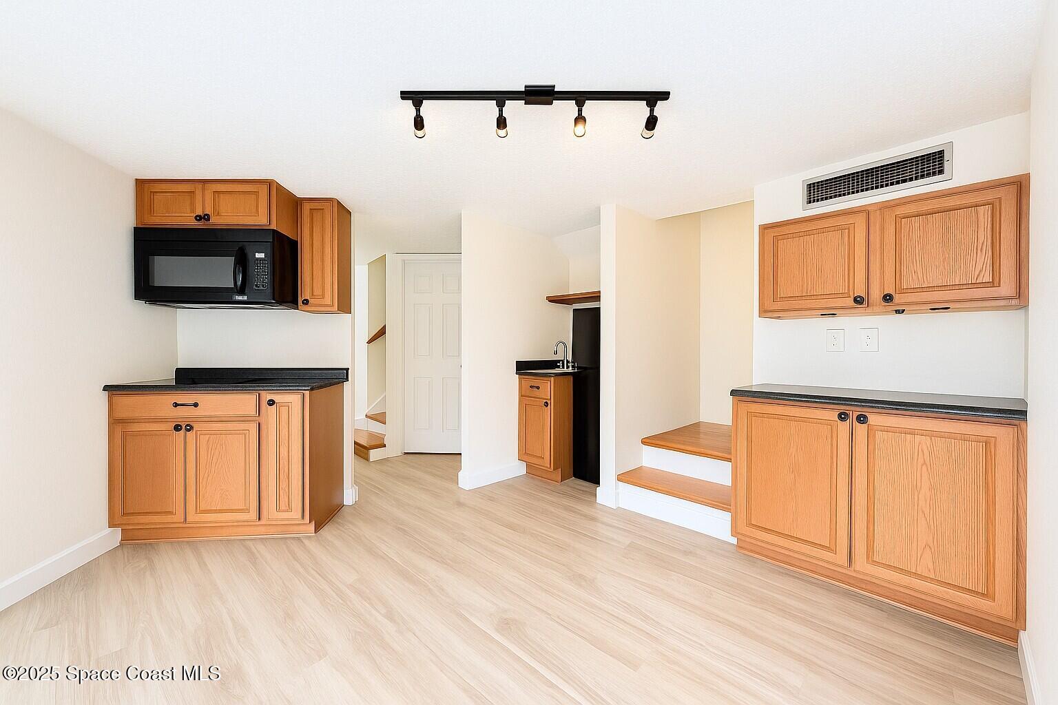 1021 Palmer Road Rockledge, FL 32955 - Photo 18 of 23 a kitchen with stainless steel appliances granite countertop a refrigerator microwave and sink