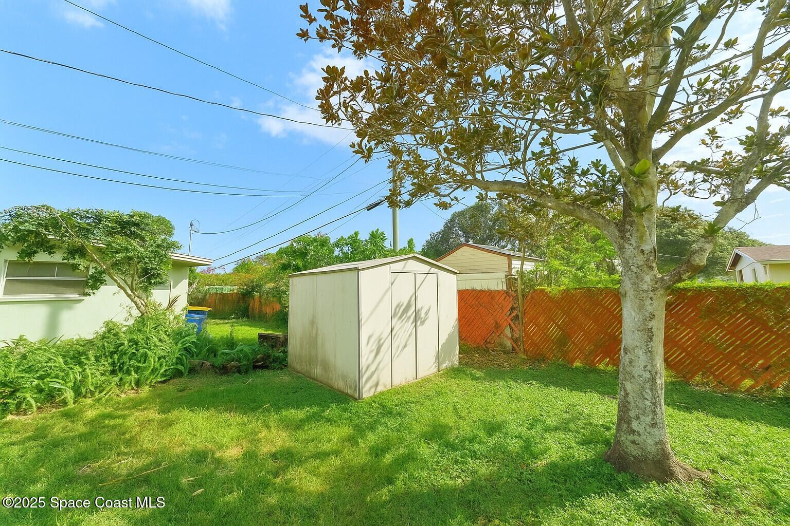 1021 Palmer Road Rockledge, FL 32955 - Photo 22 of 23 a backyard of a house with plants and tree