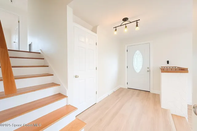 a view of front door and wooden floor