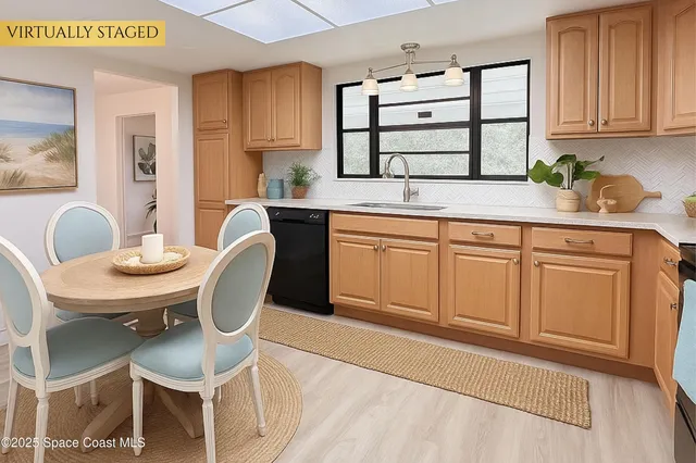 a spacious bedroom with a bed a chandelier and a potted plant