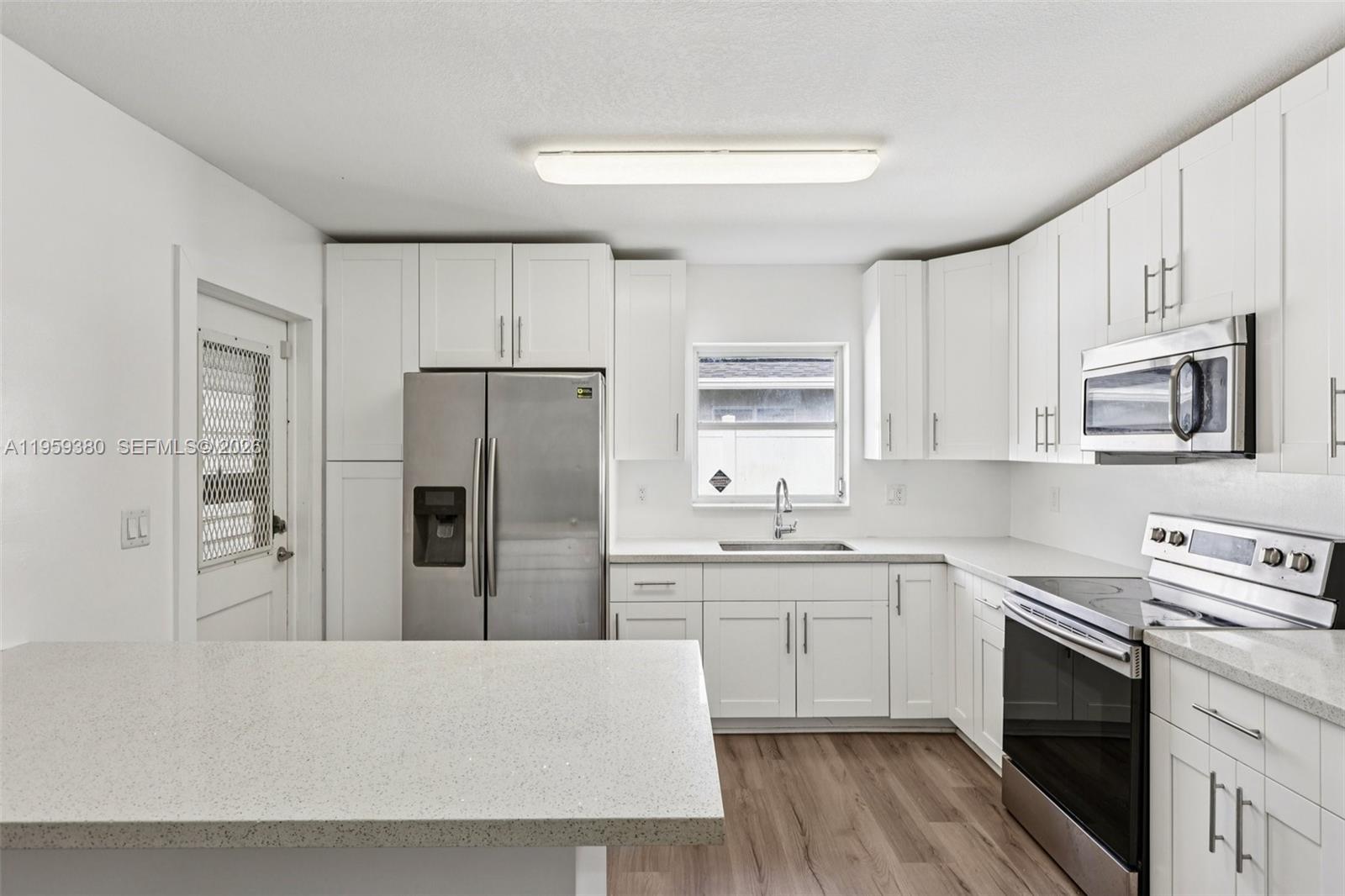 2720 Northeast 25th Terrace Boca Raton, FL 33431 - Photo 13 of 40 a kitchen with stainless steel appliances granite countertop a refrigerator sink and stove