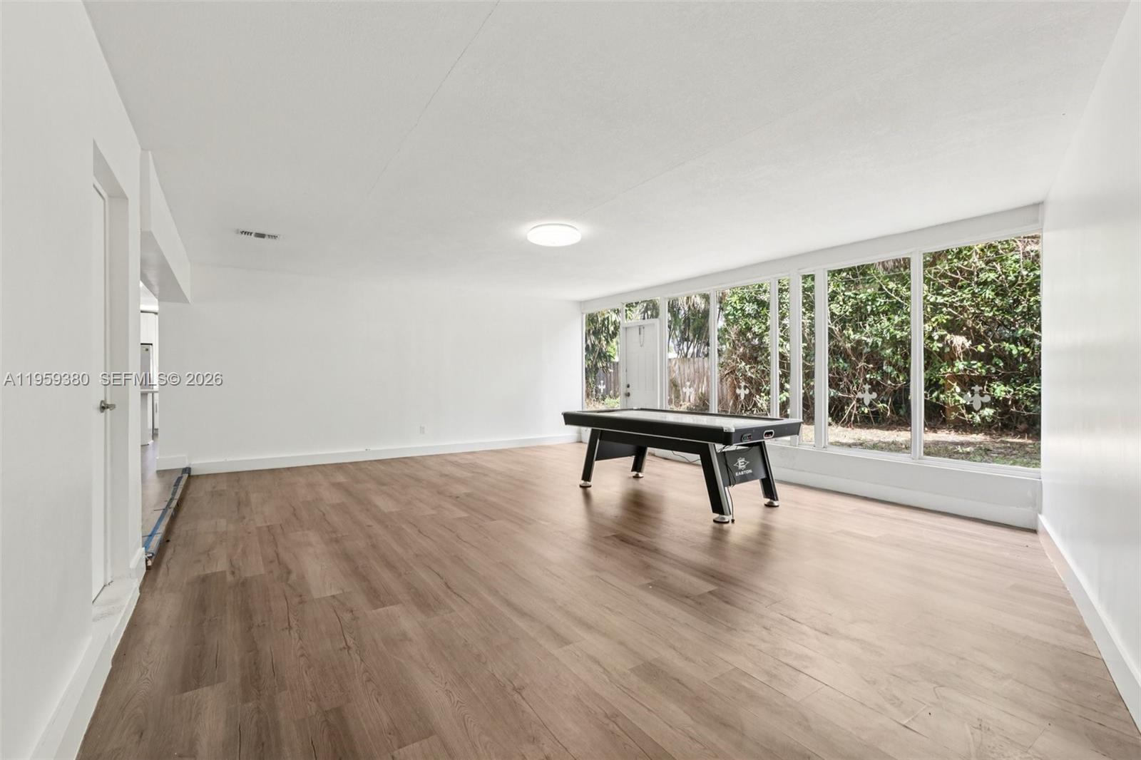 2720 Northeast 25th Terrace Boca Raton, FL 33431 - Photo 25 of 40 a view of a room with wooden floor and a window