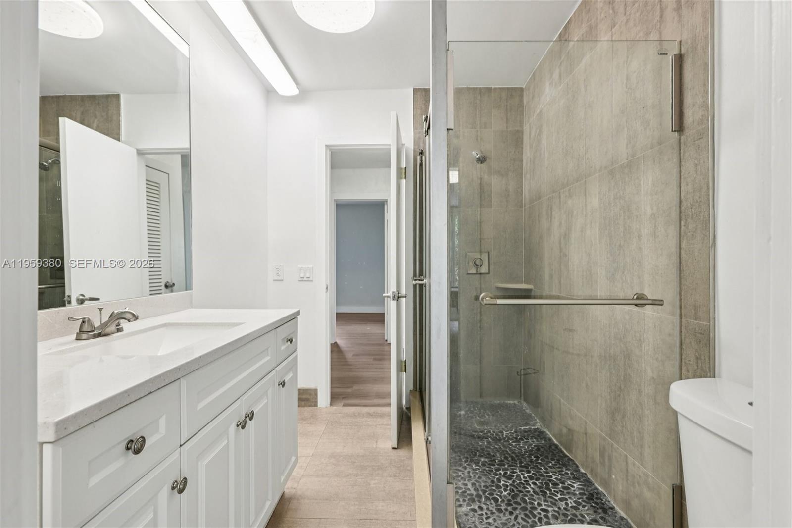 2720 Northeast 25th Terrace Boca Raton, FL 33431 - Photo 26 of 40 a bathroom with a sink a toilet and shower