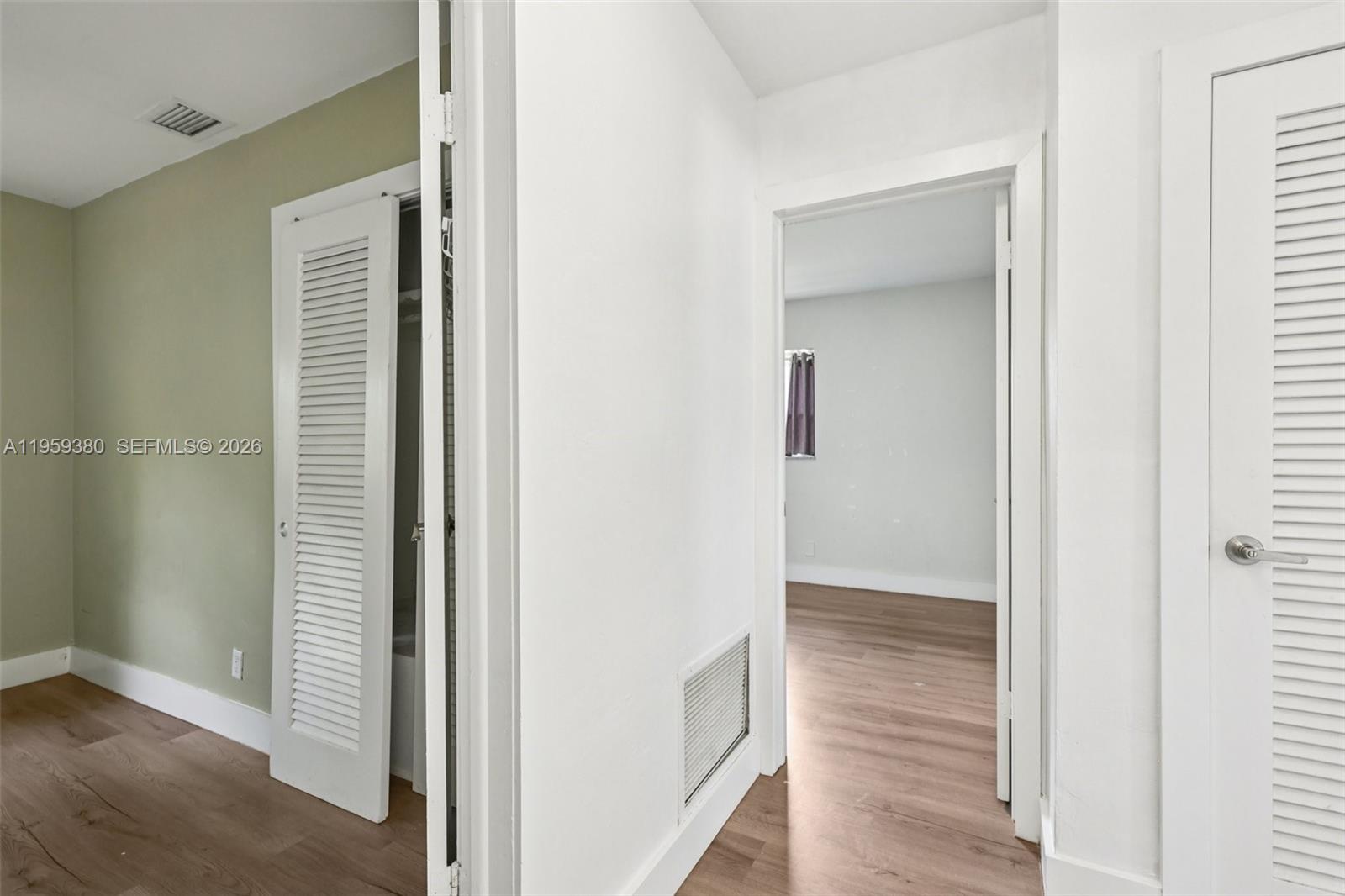 2720 Northeast 25th Terrace Boca Raton, FL 33431 - Photo 28 of 40 a view of a hallway with wooden floor