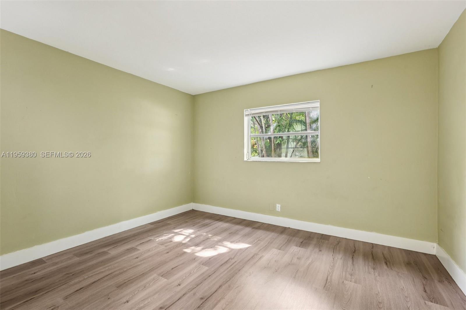 2720 Northeast 25th Terrace Boca Raton, FL 33431 - Photo 29 of 40 a view of empty room with wooden floor and fan