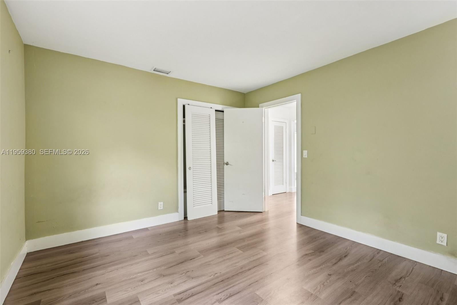 2720 Northeast 25th Terrace Boca Raton, FL 33431 - Photo 31 of 40 a view of an empty room with wooden floor