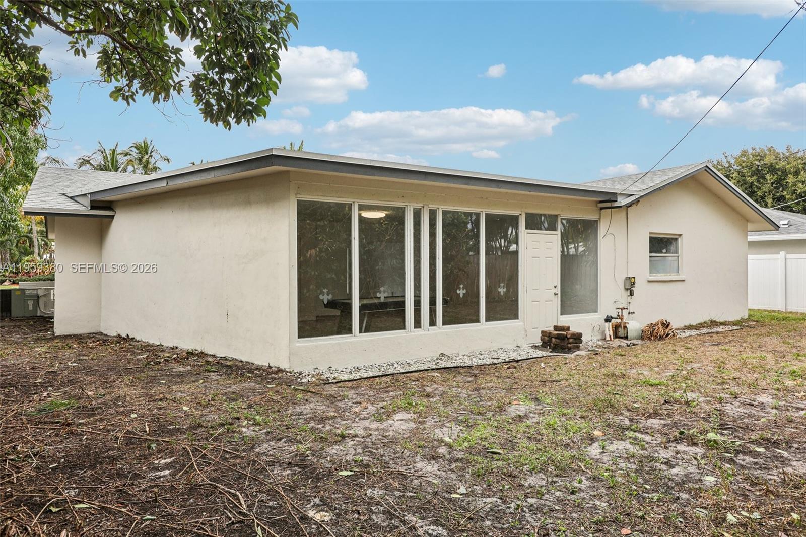 2720 Northeast 25th Terrace Boca Raton, FL 33431 - Photo 39 of 40 a front view of a house with a yard