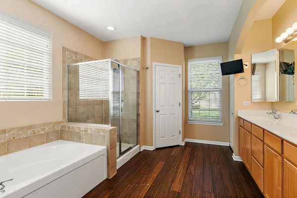 a bathroom with a tub sink and shower