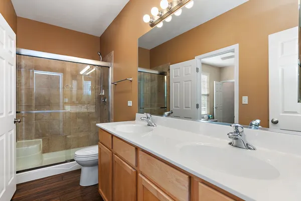 a bathroom with a sink a toilet and shower