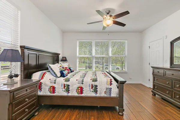 a bed sitting in a bedroom next to a window