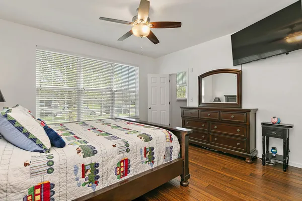 a bedroom with a bed and a chandelier
