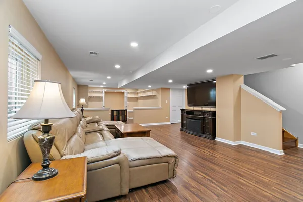 a living room with furniture and a wooden floor