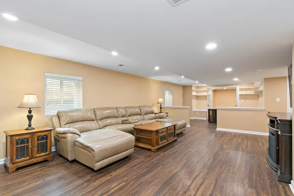 a living room with furniture and a wooden floor