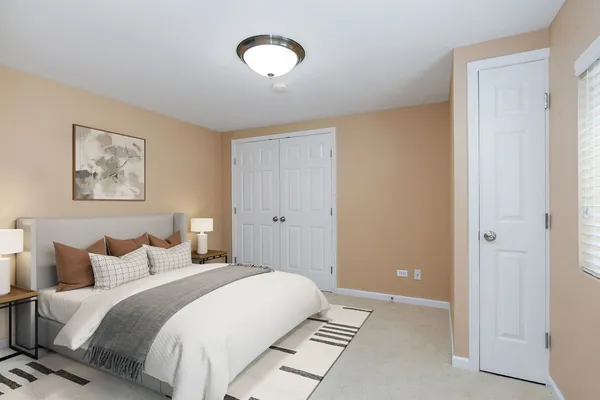 a bedroom with a bed and a painting on the wall