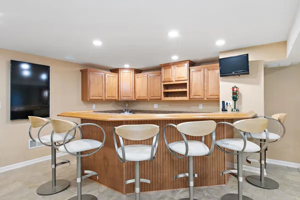 a kitchen with stainless steel appliances granite countertop a sink and a refrigerator