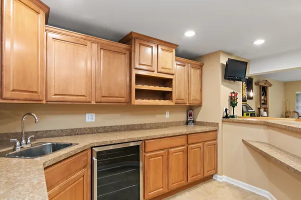 a kitchen with granite countertop stainless steel appliances a sink stove top oven and cabinets